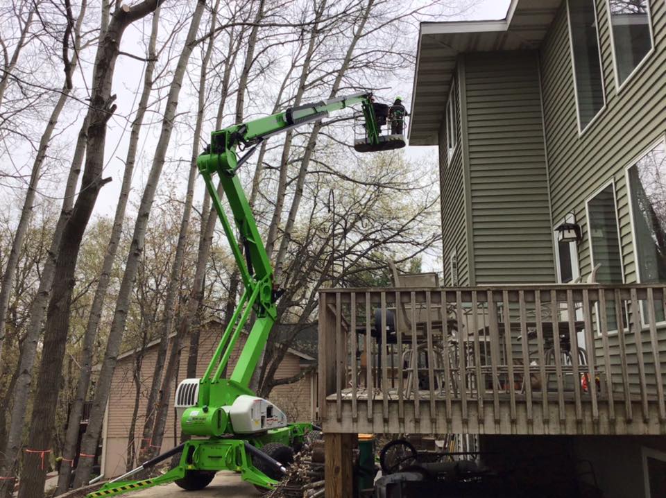 Tree service crew working from an aerial lift